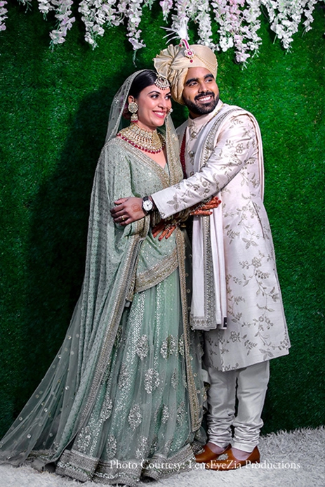 Photo of Couple on the reception with bride in a green lehenga
