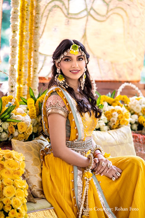 Photo of Mehendi bridal look in yellow lehenga and floral jewellery