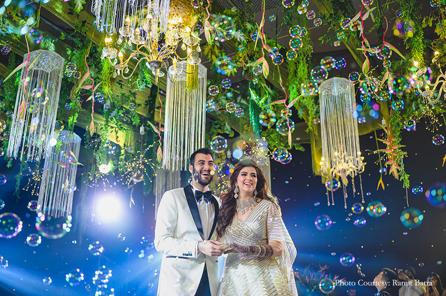 The groom wore a suave white tuxedo while the bride dazzled in a gold cocktail gown by Amit Aggarwal at Sheraton Hua Hin