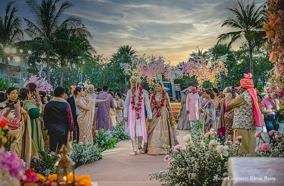 The bride wore a blush pink Sabyasachi lehenga with rich Polki and meenakari jewelry and groom wearing white, pink and gold sherwani for the wedding
