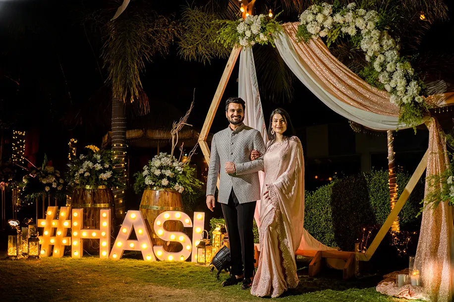 The groom wore a silver grey Jodhpuri jacket by Kunal Rawal, and the bride wore a champagne hued saree