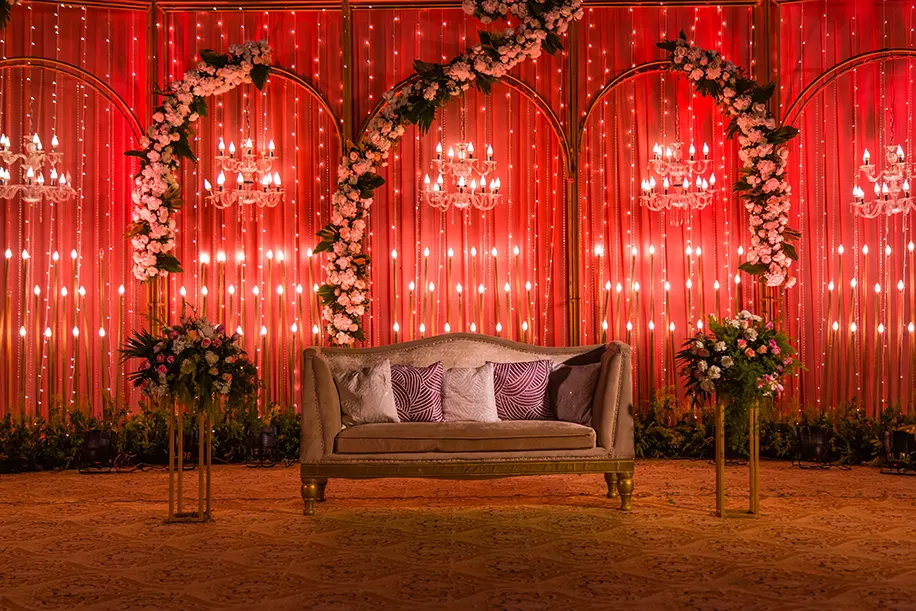 Mandap decor with red and floral backdrop
