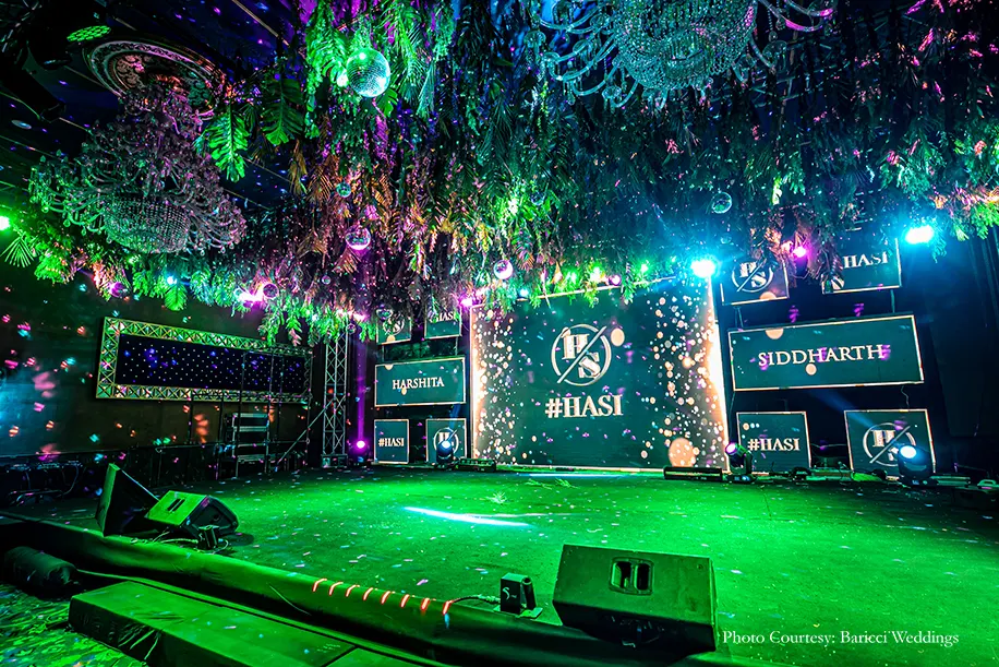 Neon hues, rich foliage canopies hung with shiny disco balls, cold pyros and chandeliers decor for the sangeet