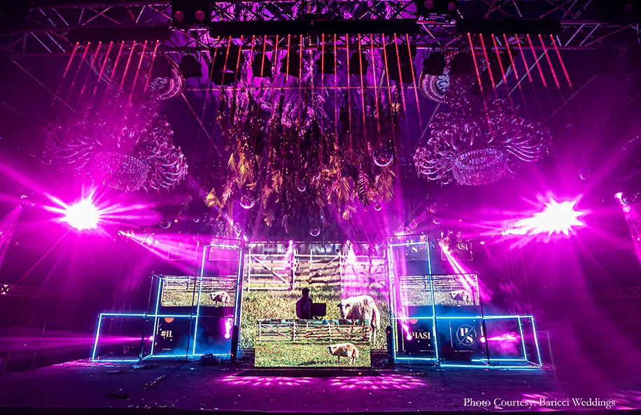 Neon hues, rich foliage canopies hung with shiny disco balls, cold pyros and chandeliers decor for the sangeet
