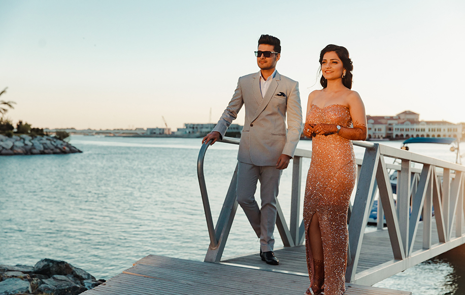 bride gold glitter body hugging dress and groom in checked three piece suit