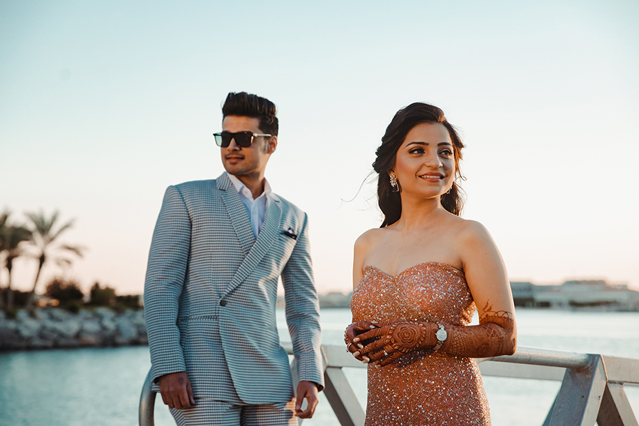 bride gold glitter body hugging dress and groom in checked three piece suit bride gold glitter body hugging dress and groom in checked three piece suit