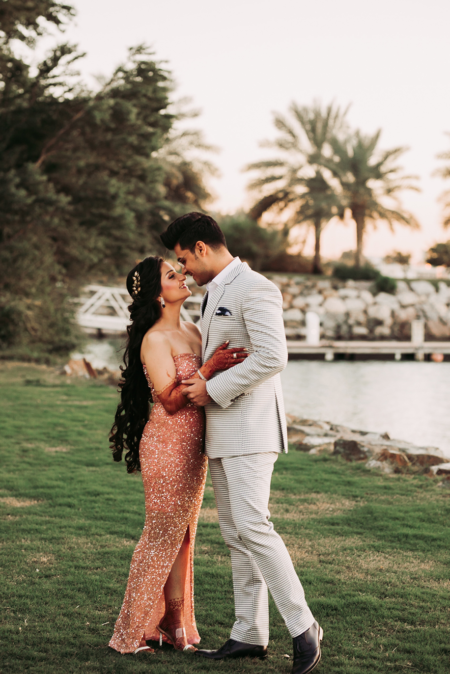 bride gold glitter body hugging dress and groom in checked three piece suit