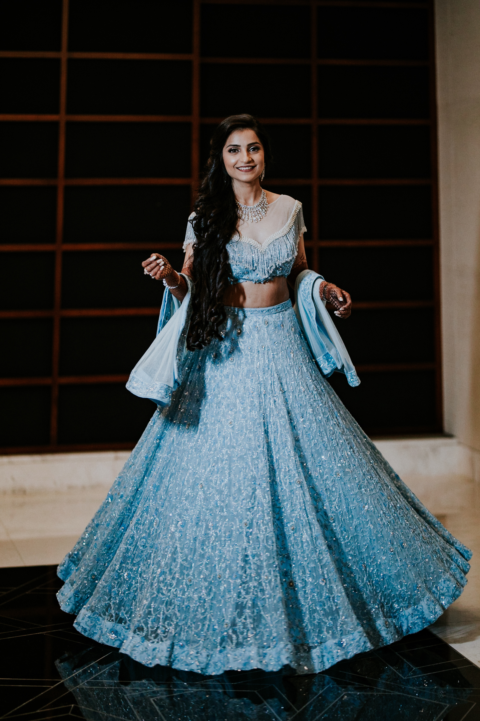 bride-to-be wearing a powder blue lehenga for sangeet
