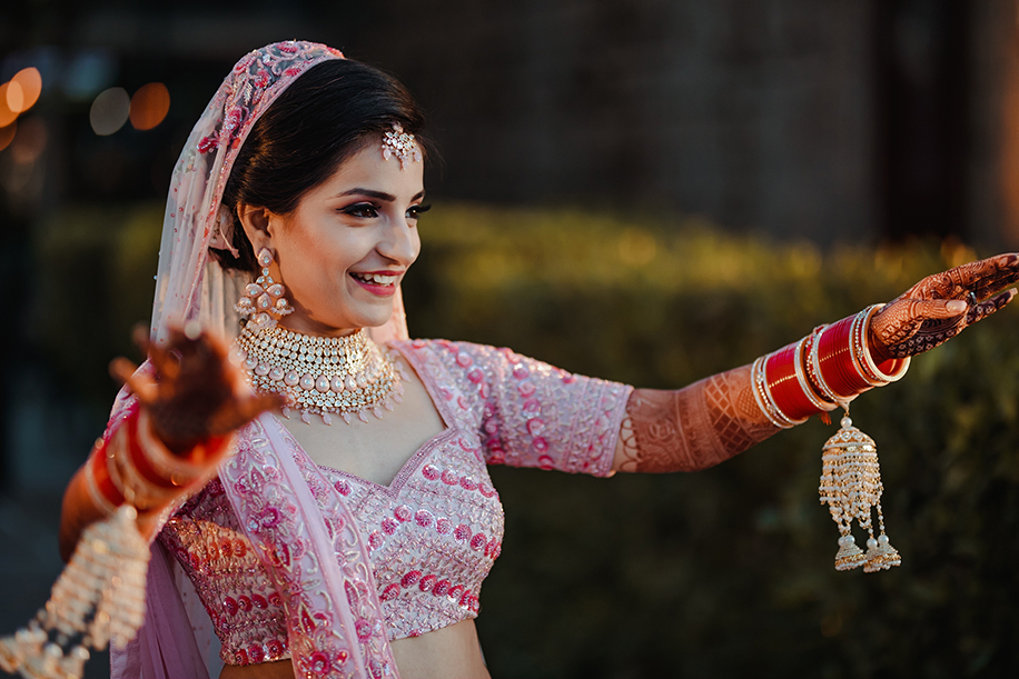 Bride in white and pink embroidered lehenga for wedding
