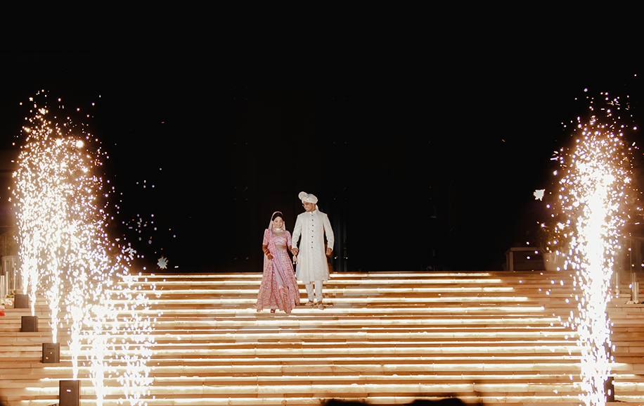 Bride wearing white and pink embroidered lehenga and groom wearing a white sequined sherwani and turban Bride wearing white and pink embroidered lehenga and groom wearing a white sequined sherwani and turban