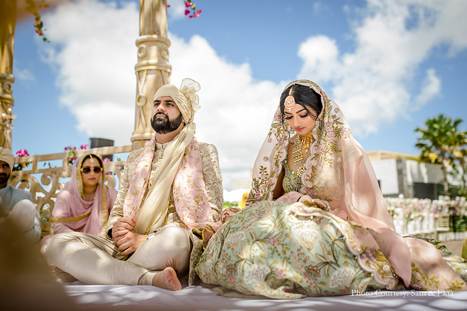 Bride wearing Pista green and peach lehenga by Anamika Khanna and groom wearing Off-white sherwani by Sabyasachi for wedding at Bali