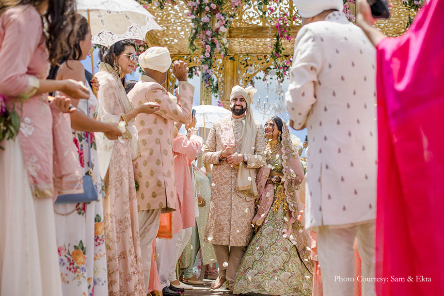 Bride wearing Pista green and peach lehenga by Anamika Khanna and groom wearing Off-white sherwani by Sabyasachi for wedding at Bali