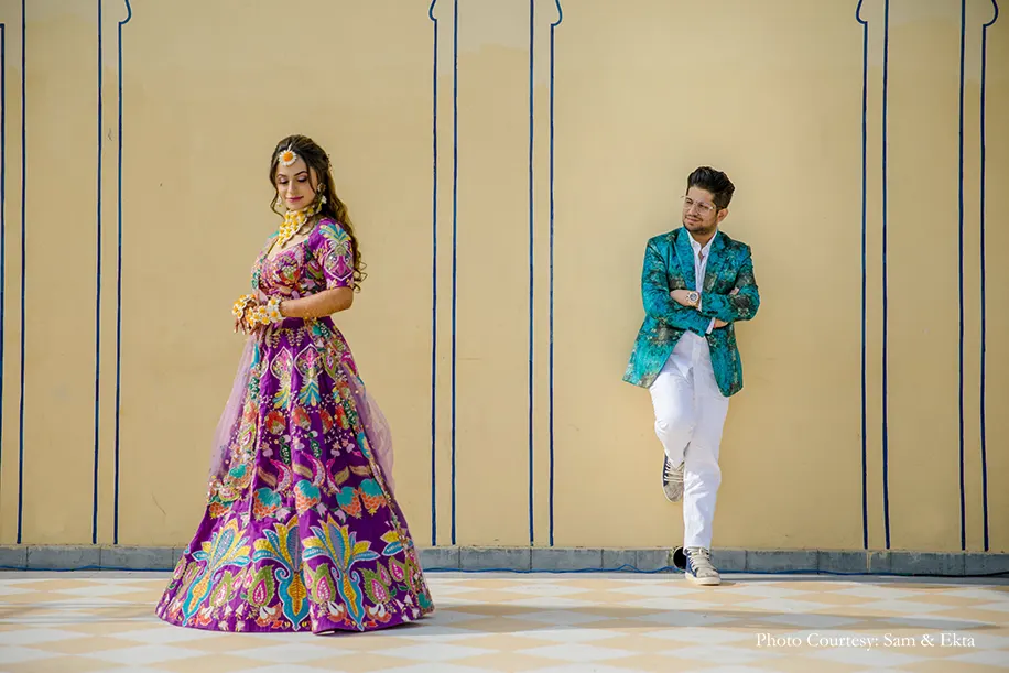 Bride in purple embroidery lehenga and groom in Blue jacket for the pool party