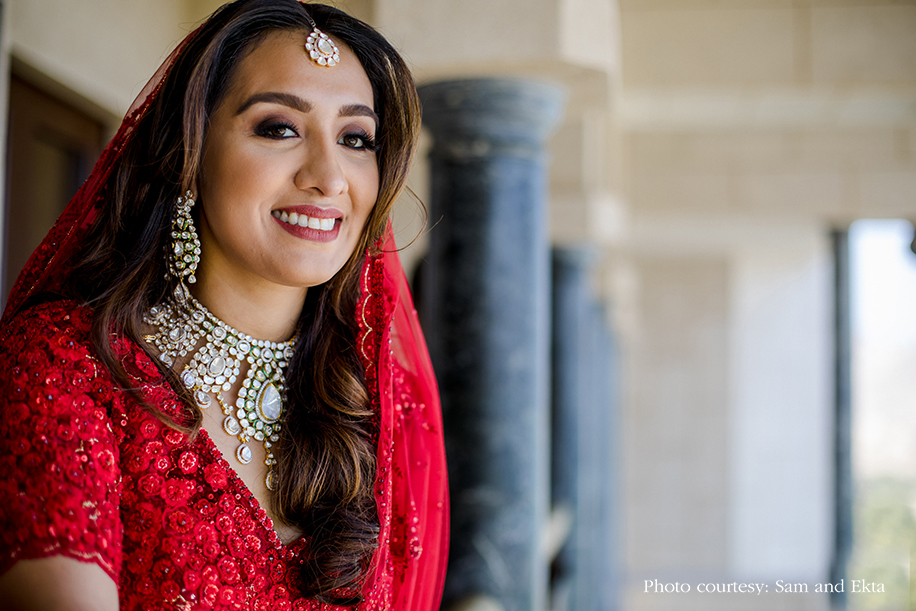 Bride in Red Sabyasachi lehenga and kundan jewelry at Oman