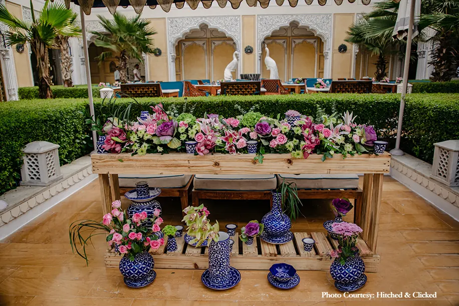 floral decor combined with traditional vases and other elements in blue and white for haldi