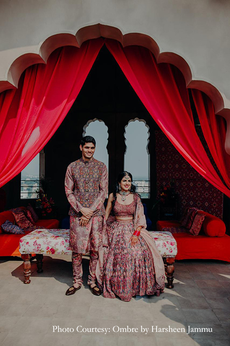 Bride in multicolored lehenga and groom in multi-color sherwani