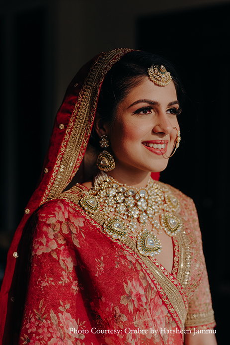 bride in red Sabyasachi lehenga and kundan jewelry