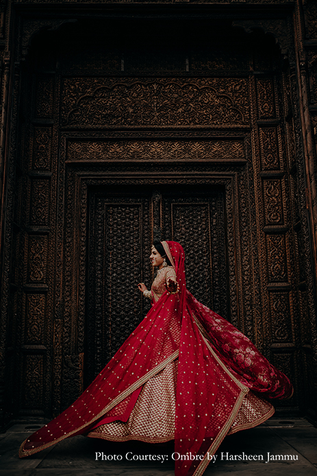 bride in red Sabyasachi lehenga and kundan jewelry