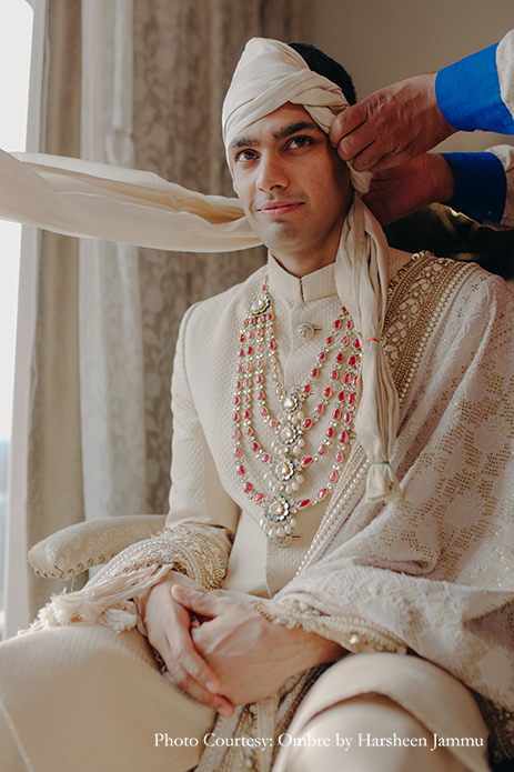 groom in white bandhgala sherwani with shawl