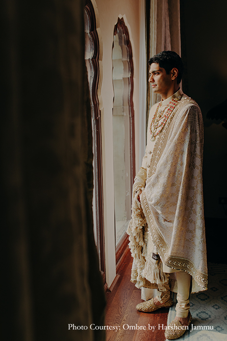 groom in white bandhgala sherwani with shawl