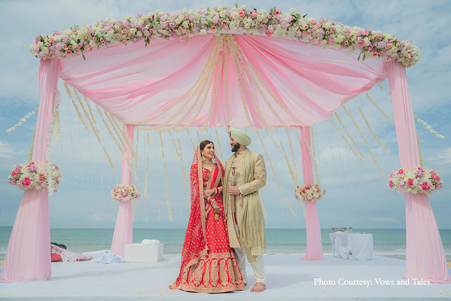 bride in red lehenga and groom in off white sherwani paired with a sage green turban at thailand
