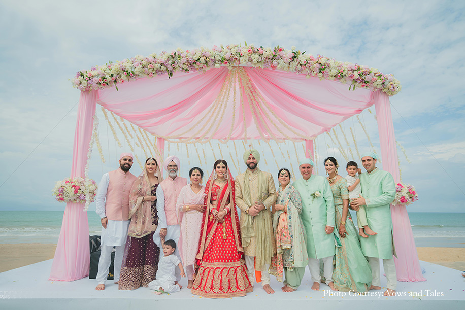bride in red lehenga and groom in off white sherwani paired with a sage green turban for anand karaj at thailand
