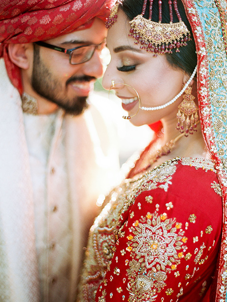 Muslim bridal look in red lehenga while Groom in off-white sherwani and red safa