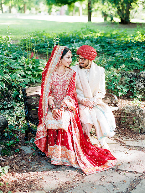 Muslim bridal look in red lehenga while Groom in off-white sherwani and red safa