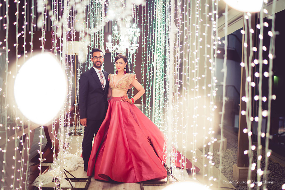 bride wore a stunning rose lehenga by Manish Malhotra and groom in three piece