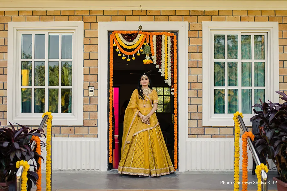 Bride wearing yellow lehenga for haldi