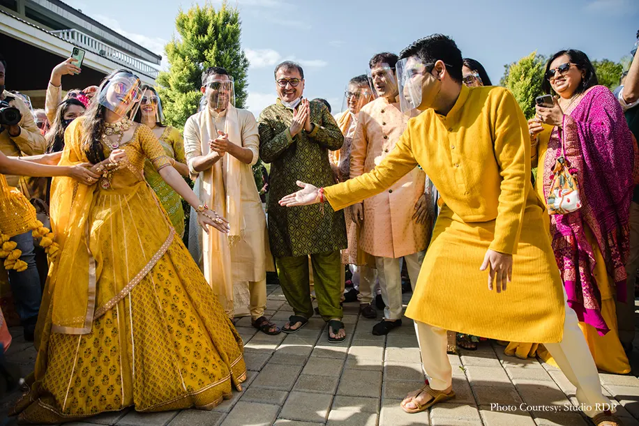 Couple wearing yellow outfits for the haldi