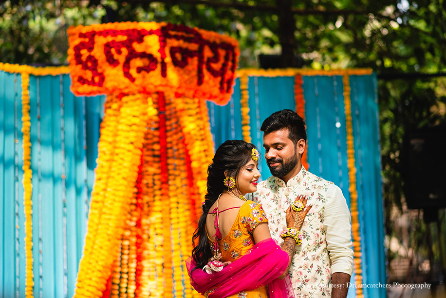 bride in vibrant yellow lehenga and groom in floral Nehru Jacket from Maanyavar