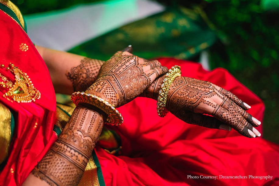 Bride in stunning red saree for mehendi