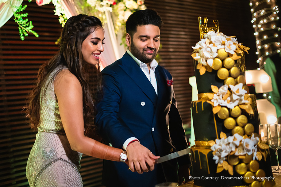 Bride wearing Blush gown by Babita Malkani and groom wearing a navy blue jacket by Stan Ahuja Tailoring for cocktail