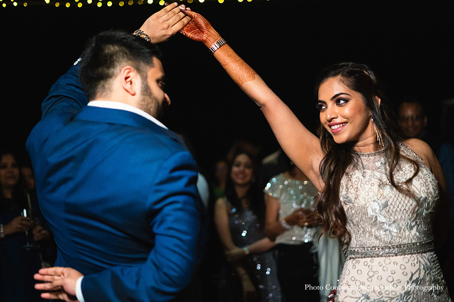 Bride wearing Blush gown by Babita Malkani and groom wearing a navy blue jacket by Stan Ahuja Tailoring for cocktail