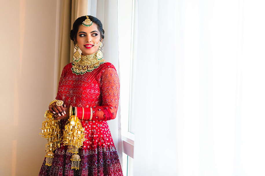 Bride wearing bright red anarkali with detailed embroidery