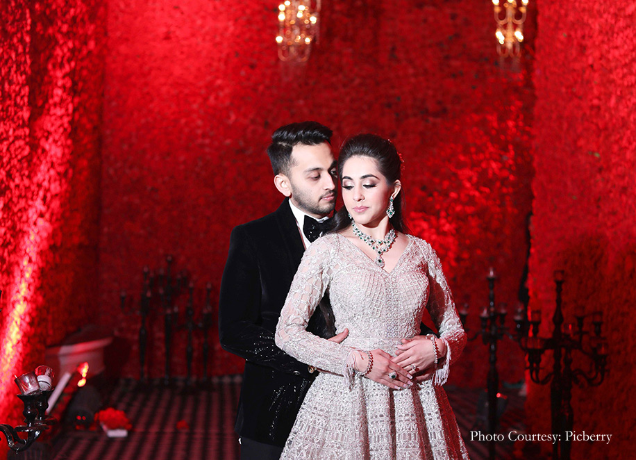 Bride in shimmering gown by Falguni and Shane Peacock and groom in suave tuxedo by Gaurav Gupta for the engagement