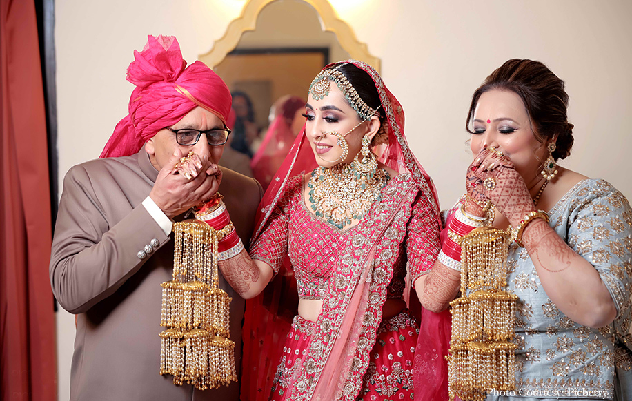 Bride wearing red lehenga and kundan jewelry