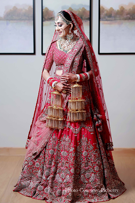 Bride wearing red lehenga and kundan jewelry