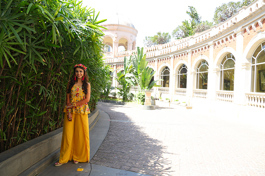 Yellow Outfit by Kalki Fashion With Floral Accessories and Pink Tassel Earrings