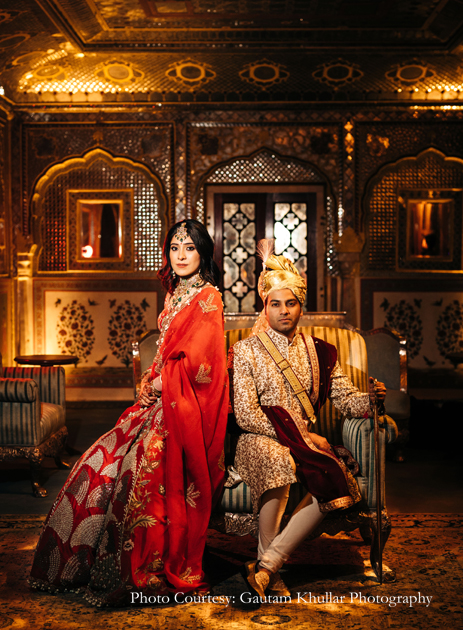 Red lehenga by Anamika Khanna and white and gold sherwani from SVA By Sonam & Paras Modi