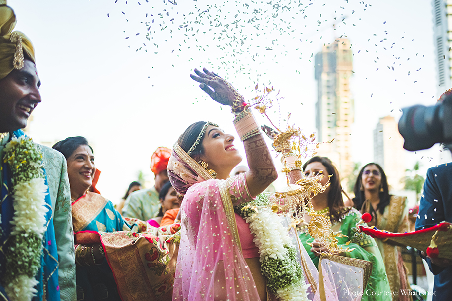 Bride wearing onion pink lehenga by Neeta Lulla with gold motifs, pearls, and sequins work