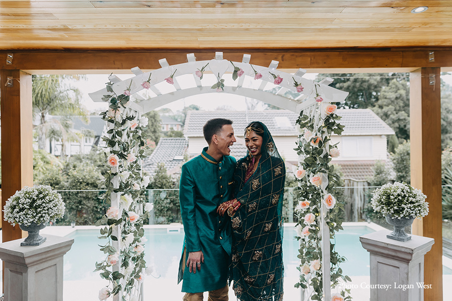 Bride wearing Pakistani suit and Groom wearing gold and turquoise sherwani