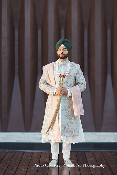 Groom wore an ensemble in mint and blush by Study by Janak for Anand Karaj