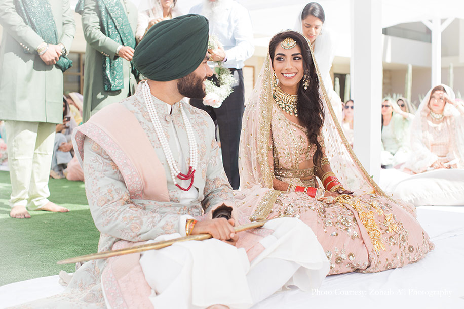 Bride wearing delicate blush lehenga by Astha Narang and Groom wore an ensemble in mint and blush by Study by Janak for Anand Karaj