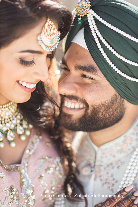 Bride wearing delicate blush lehenga by Astha Narang and Groom wore an ensemble in mint and blush by Study by Janak for Anand Karaj