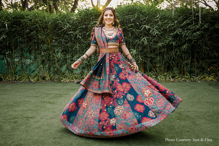Bride in teal and pink lehenga by Debyanti and Co