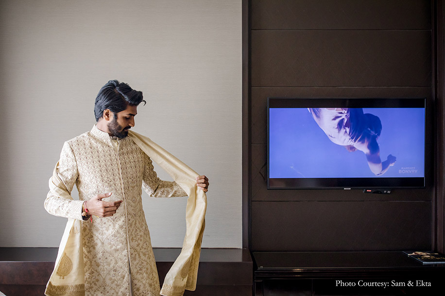 Groom in a white and gold sherwani by Anita Dongre
