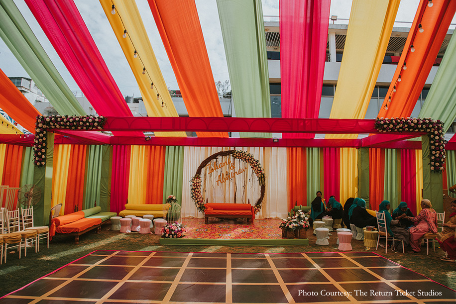 mehndi decor under a gazebo adorned with colorful drapes