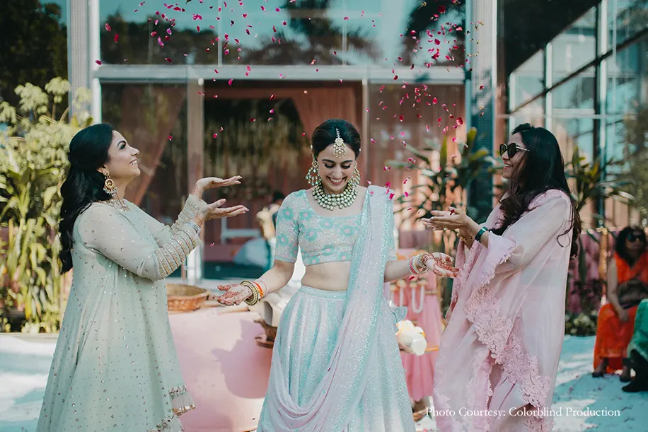 Bride wearing Powder blue and light pink lehenga with her squade
